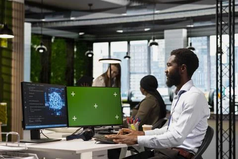 Technician using green screen PC to code, testing AI applications Stock Photos