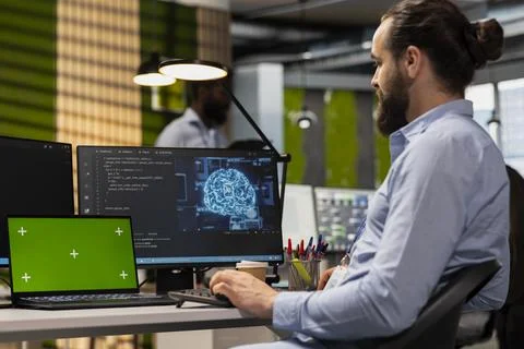 Technician using green screen tablet to code AI algorithms 스톡 사진