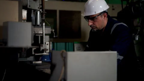 A technician is using a grinding machine to grind and shape automotive parts Stock Footage 339209741