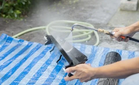 Technician using a high pressure water hose to maintenance and cleaning fil.. Stock Photos