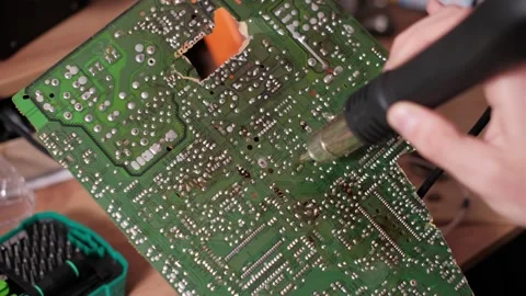 Technician Using Hot Air Gun on Green PCB Back Solder Joints Stock Footage 306618647