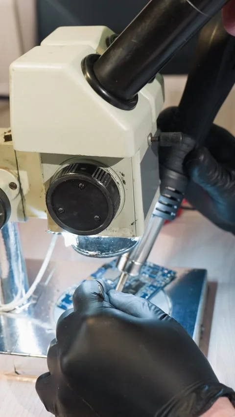 Technician Using Microscope and Soldering Tools to Repair Circuit Board Video stock 310490862