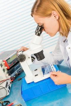 Technician using microscope Stock Photos