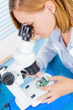 Technician using microscope Stock Photos