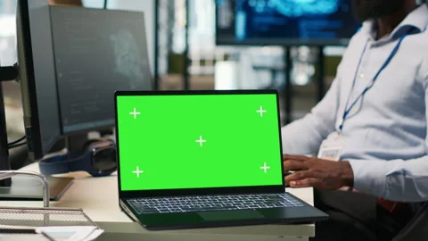 Technician using mockup laptop next to office coworkers developing applications Stock Footage 313164974