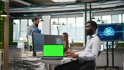 Technician using mockup laptop next to office coworkers developing applications Stock Footage 313166765