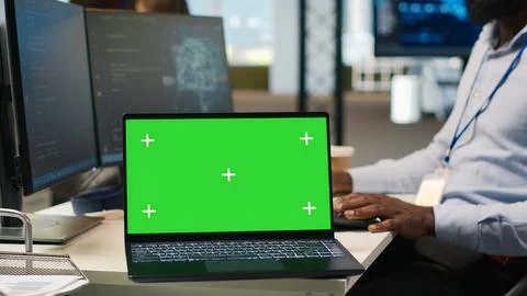 Technician using mockup laptop next to office coworkers developing applications Foto stock