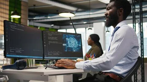 Technician using mockup laptop next to office coworkers developing applications Stock Photos