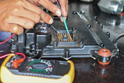 Technician using multimeter probes to test car engine electronic control un.. Stock Photos