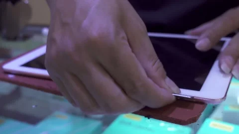 Technician using a razor blade to open Ipad,4K Stock Footage 315098672