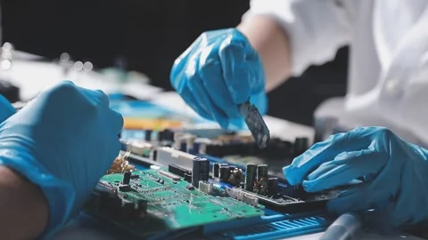 Technician using soldering iron on electronic circuit board for hardware re.. Stock Footage 345605852