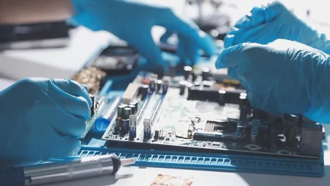 Technician using soldering iron on electronic circuit board for hardware re.. Stock Footage 345605856