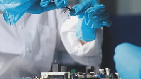Technician using soldering iron on electronic circuit board for hardware re.. Stock Footage 345605863