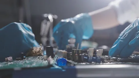 Technician using soldering iron on electronic circuit board for hardware re.. Stock Footage 345605871
