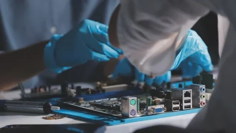 Technician using soldering iron on electronic circuit board for hardware re.. Stock Footage 345605884