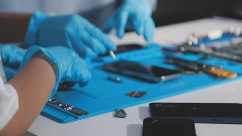 Technician using soldering iron on electronic circuit board for hardware re.. Stock Footage 345605887