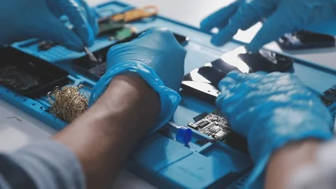 Technician using soldering iron on electronic circuit board for hardware re.. Stock Footage 345605891