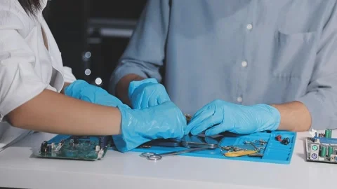Technician using soldering iron on electronic circuit board for hardware re.. Stock Footage 345605908