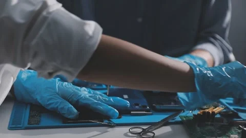 Technician using soldering iron on electronic circuit board for hardware re.. Stock Footage 345605909