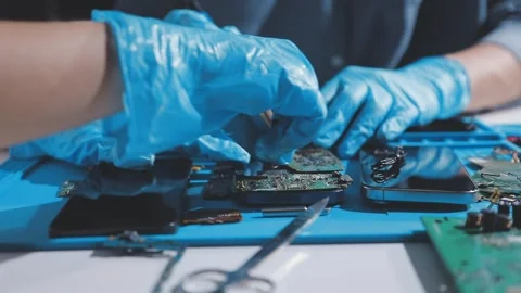 Technician using soldering iron on electronic circuit board for hardware re.. Stock Footage 345605920
