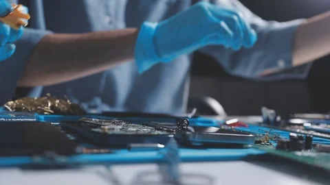 Technician using soldering iron on electronic circuit board for hardware re.. Stock Footage 345605921