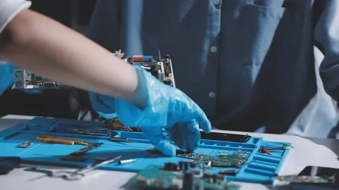 Technician using soldering iron on electronic circuit board for hardware re.. Stock Footage 345605927