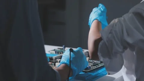 Technician using soldering iron on electronic circuit board for hardware re.. Stock Footage 345605937