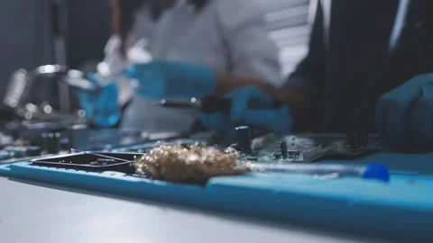 Technician using soldering iron on electronic circuit board for hardware re.. Stock Footage 345605942