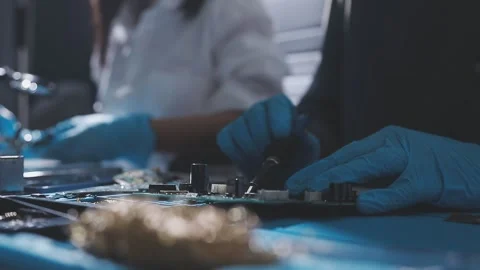 Technician using soldering iron on electronic circuit board for hardware re.. Stock Footage 345605951