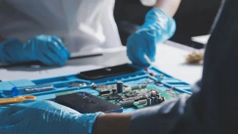 Technician using soldering iron on electronic circuit board for hardware re.. Stock Footage 345605977