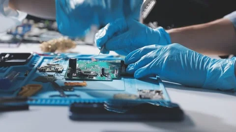 Technician using soldering iron on electronic circuit board for hardware re.. Stock Footage 345605978