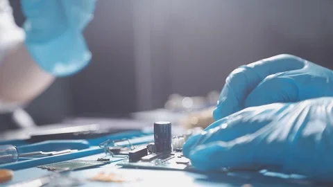 Technician using soldering iron on electronic circuit board for hardware re.. Stock Footage 345605984