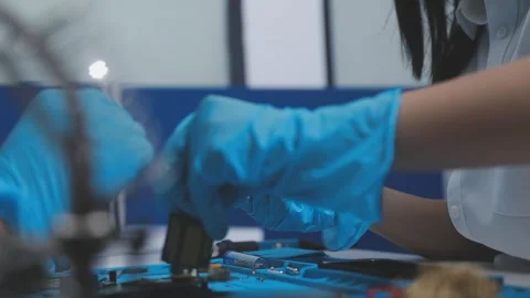 Technician using soldering iron on electronic circuit board for hardware re.. Stock Footage 345605995