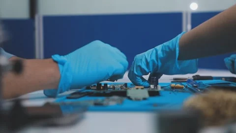 Technician using soldering iron on electronic circuit board for hardware re.. Stock Footage 345605999