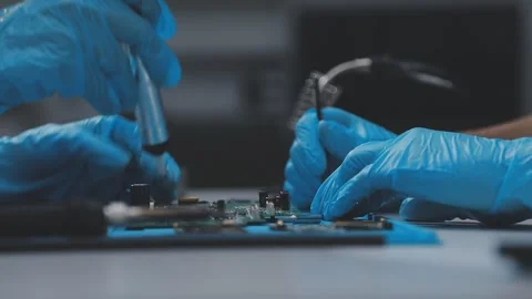 Technician using soldering iron on electronic circuit board for hardware re.. Stock Footage 345606000