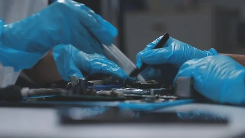 Technician using soldering iron on electronic circuit board for hardware re.. Stock Footage 345606008