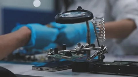 Technician using soldering iron on electronic circuit board for hardware re.. Stock Footage 345606012