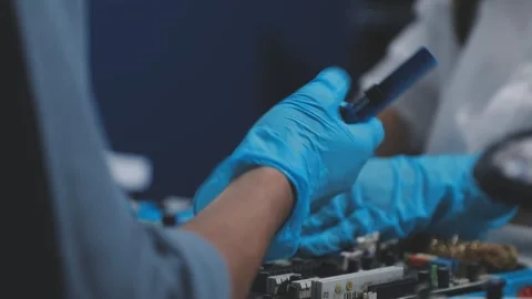 Technician using soldering iron on electronic circuit board for hardware re.. Stock Footage 345606014