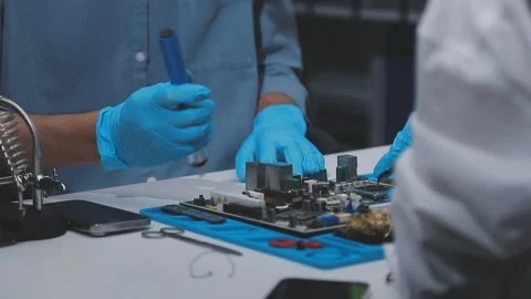 Technician using soldering iron on electronic circuit board for hardware re.. Stock Footage 345606018