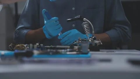 Technician using soldering iron on electronic circuit board for hardware re.. Stock Footage 345606024