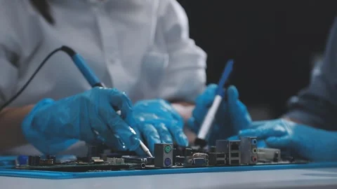 Technician using soldering iron on electronic circuit board for hardware re.. Stock Footage 345606025