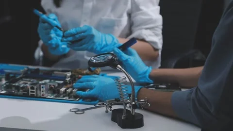 Technician using soldering iron on electronic circuit board for hardware re.. Stock Footage 345606033