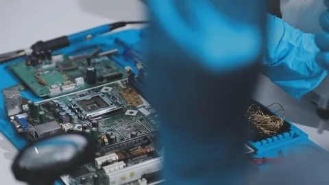 Technician using soldering iron on electronic circuit board for hardware re.. Stock Footage 345606034