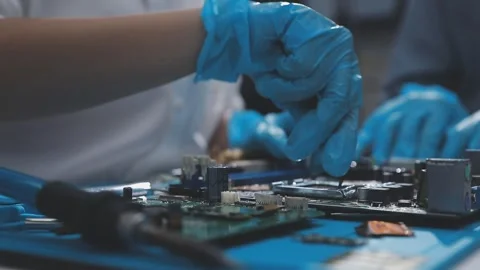Technician using soldering iron on electronic circuit board for hardware re.. Stock Footage 345606046