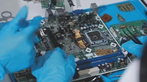 Technician using soldering iron on electronic circuit board for hardware re.. Stock Footage 345606047