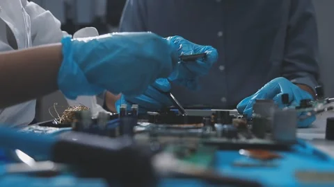 Technician using soldering iron on electronic circuit board for hardware re.. Stock Footage 345606052