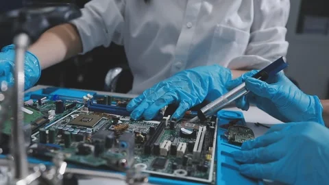 Technician using soldering iron on electronic circuit board for hardware re.. Stock Footage 345606054