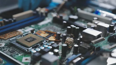 Technician using soldering iron on electronic circuit board for hardware re.. Stock Footage 345606058