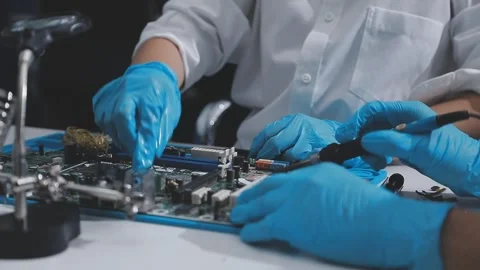 Technician using soldering iron on electronic circuit board for hardware re.. Stock Footage 345606065