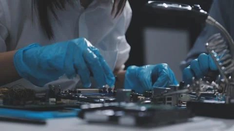 Technician using soldering iron on electronic circuit board for hardware re.. Stock Footage 345606066